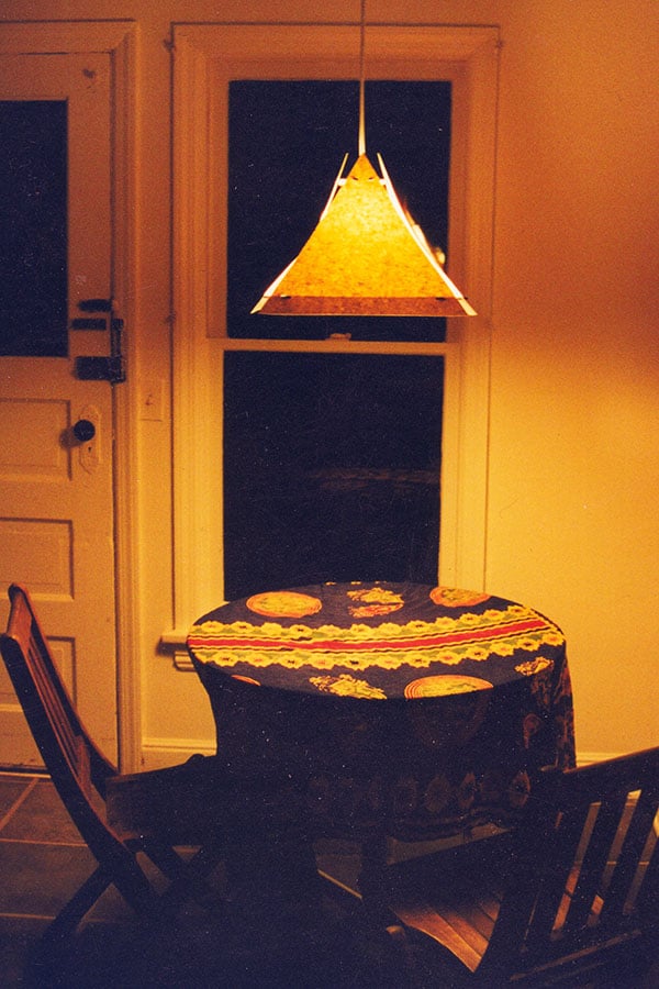 Hanging Lamp by Yana Frank seen lighting up a table and chairs
